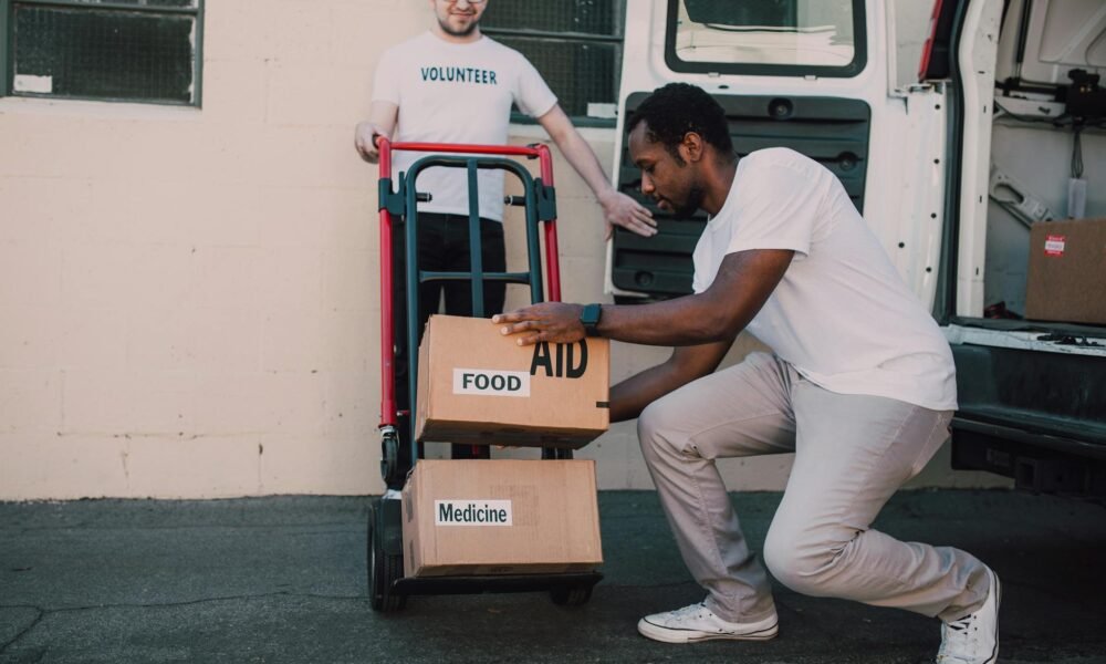 two men carrying boxes