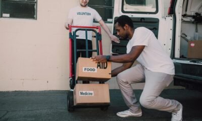 two men carrying boxes